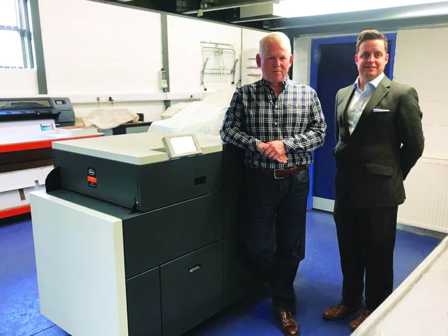 CLC | Two men operating the PowerSquare 160 Booklet Maker in a factory.